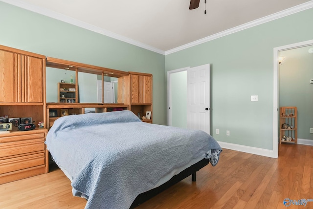 bedroom with crown molding, light wood-style flooring, a ceiling fan, and baseboards