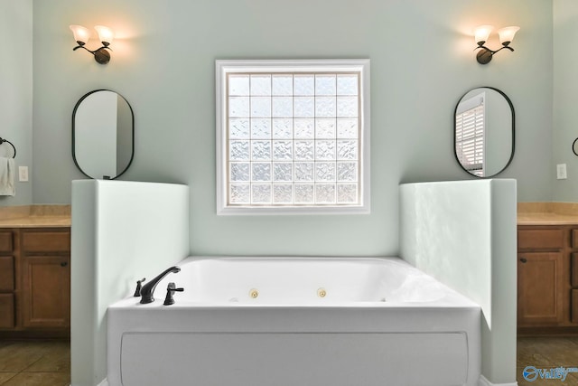 full bath with plenty of natural light, vanity, and a whirlpool tub