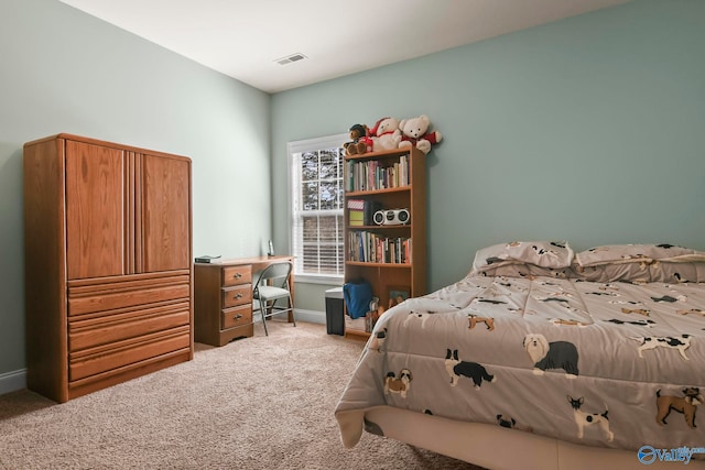carpeted bedroom featuring baseboards and visible vents