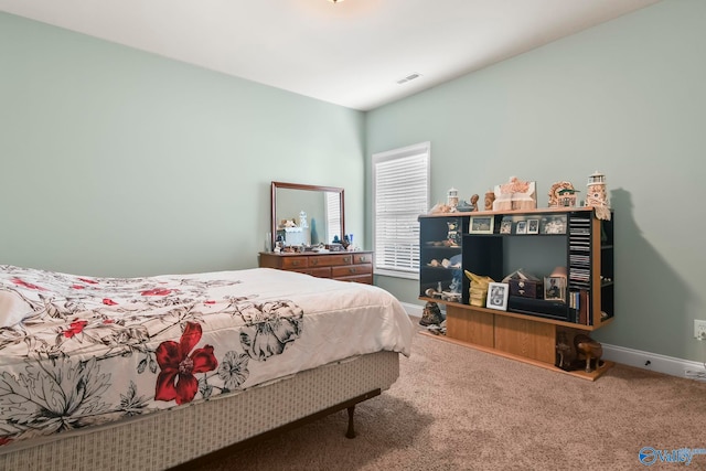carpeted bedroom with visible vents and baseboards