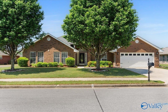 view of front of property with a garage, driveway, a front lawn, and brick siding