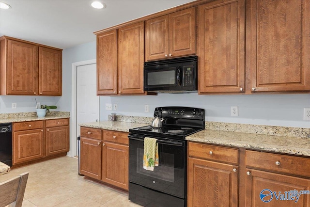 kitchen featuring recessed lighting, light tile patterned flooring, brown cabinets, and black appliances