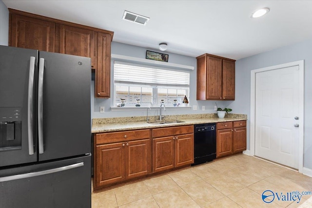 kitchen featuring a sink, stainless steel fridge with ice dispenser, dishwasher, light tile patterned floors, and visible vents
