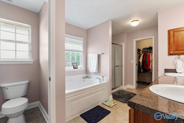 bathroom featuring a walk in closet, toilet, baseboards, a shower stall, and a bath