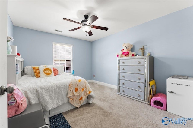 carpeted bedroom with a ceiling fan, baseboards, and visible vents