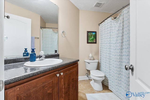 bathroom with a textured ceiling, visible vents, tile patterned flooring, vanity, and toilet