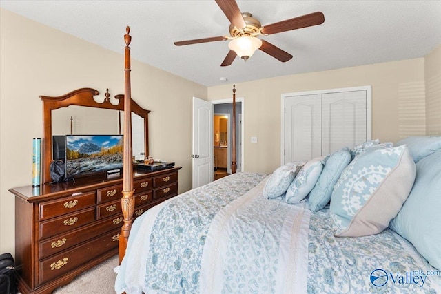 bedroom with ceiling fan, light carpet, and a closet