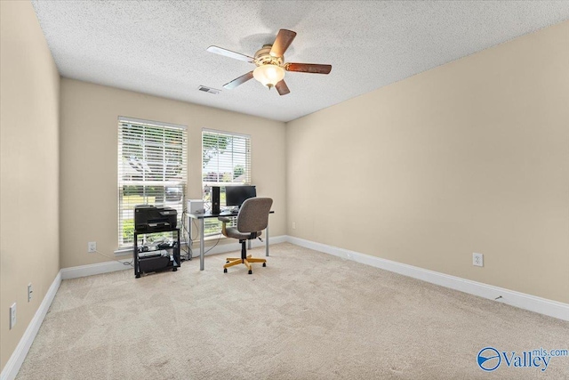 home office featuring baseboards, a ceiling fan, a textured ceiling, and carpet