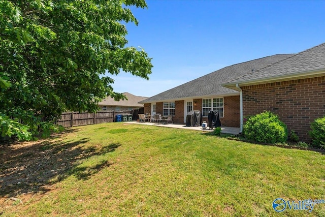 view of yard with fence and a patio area