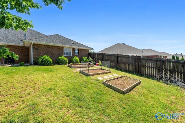 view of yard with a fenced backyard and a vegetable garden