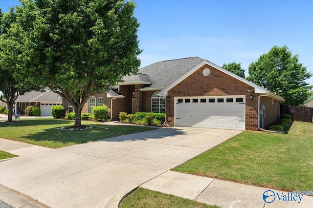 view of front of home featuring driveway, a garage, brick siding, fence, and a front lawn