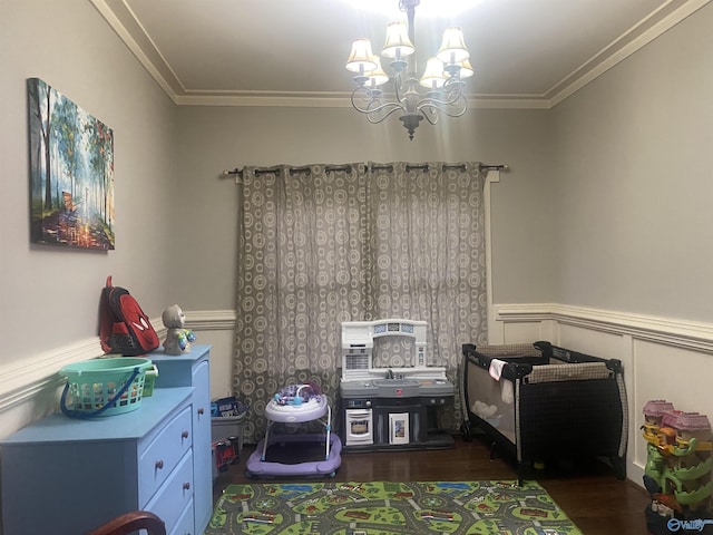 playroom with crown molding, wood finished floors, a wainscoted wall, and a chandelier