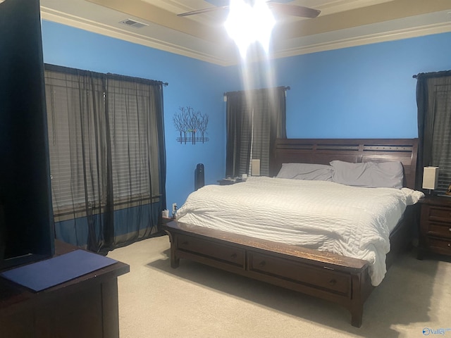 bedroom featuring a ceiling fan, visible vents, carpet floors, and ornamental molding