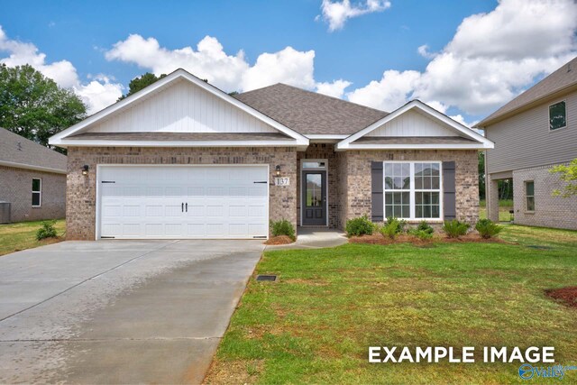 craftsman inspired home with central AC, a front yard, and a garage