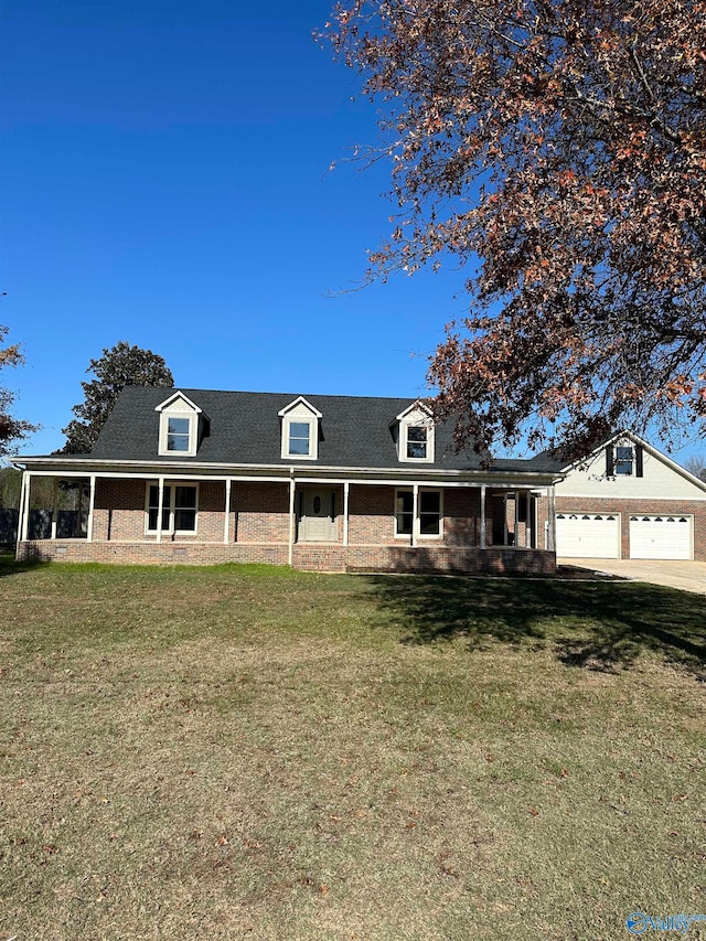 view of front of home with a front yard, a porch, and a garage