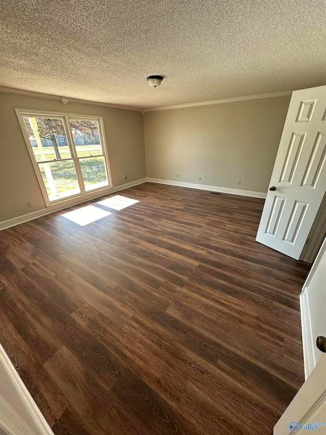 spare room featuring a textured ceiling and dark wood-type flooring