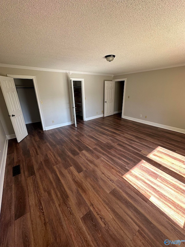 unfurnished bedroom featuring crown molding, dark hardwood / wood-style flooring, and a textured ceiling