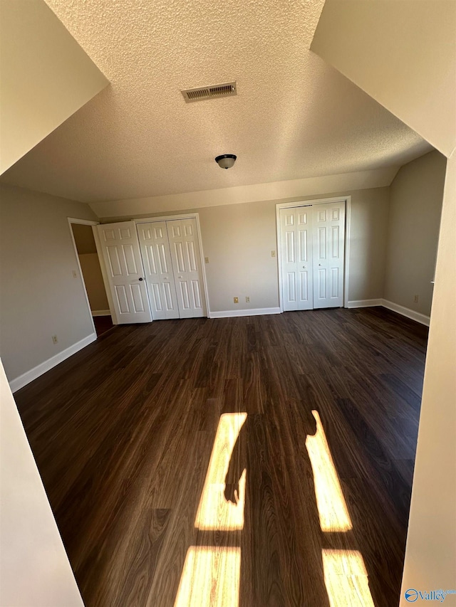 unfurnished bedroom featuring dark hardwood / wood-style floors and a textured ceiling