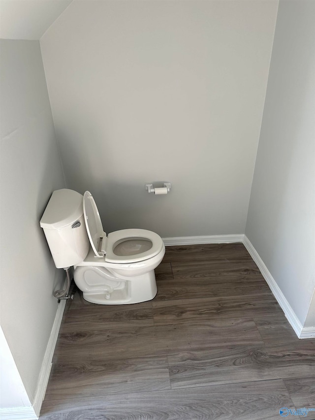 bathroom featuring hardwood / wood-style floors and toilet