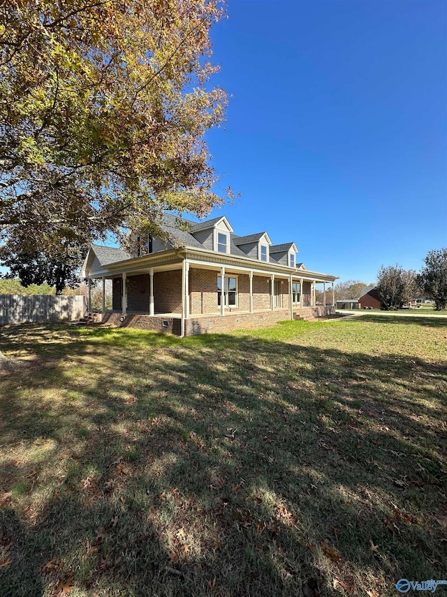 rear view of house featuring a lawn