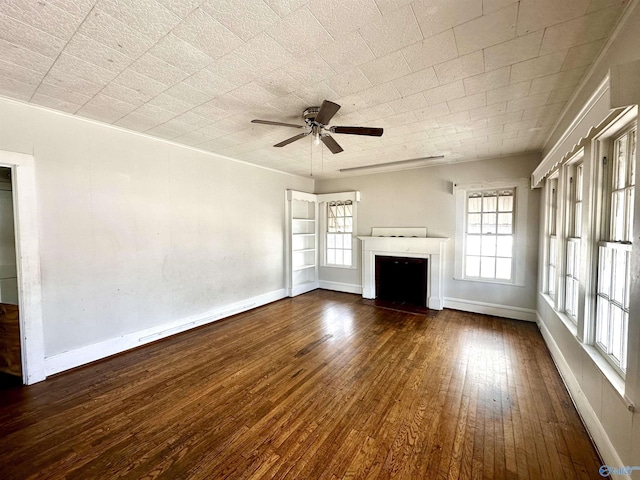 unfurnished living room with ceiling fan and dark hardwood / wood-style floors