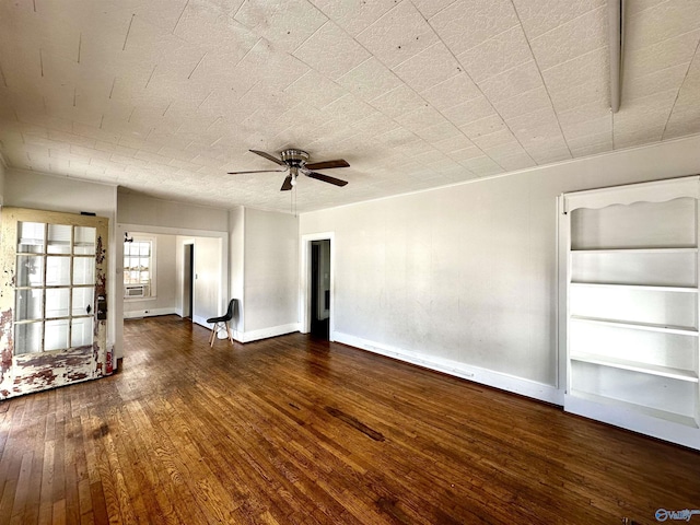 unfurnished living room with ceiling fan and dark hardwood / wood-style flooring