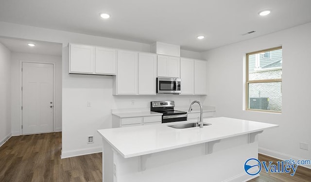 kitchen featuring white cabinetry, dark hardwood / wood-style flooring, stainless steel appliances, sink, and a center island with sink