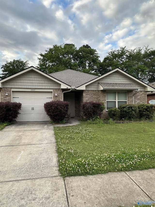 29929 Park Hill Dr, Madison, AL 35757 - ranch-style house with brick siding, an attached garage, a front yard, and concrete driveway