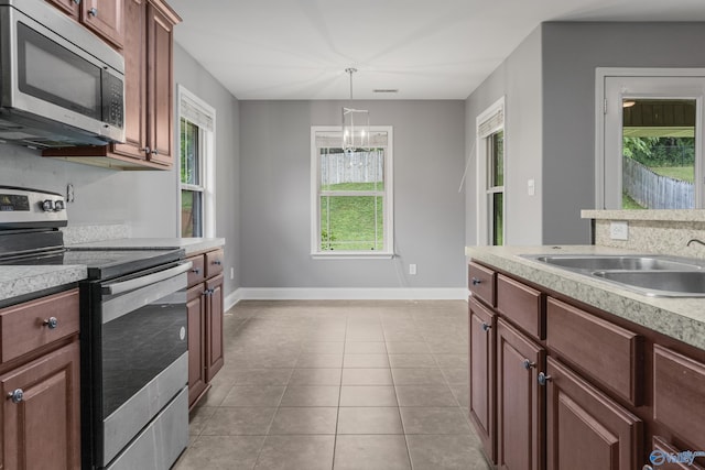 29929 Park Hill Dr, Madison, AL 35757 - kitchen featuring appliances with stainless steel finishes, a sink, light countertops, and baseboards