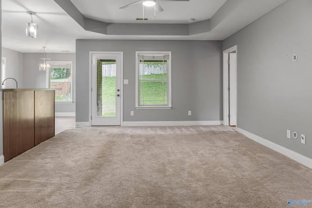 29929 Park Hill Dr, Madison, AL 35757 - unfurnished living room featuring carpet, ceiling fan, baseboards, and a tray ceiling