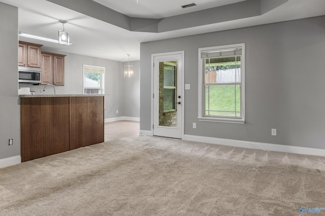 29929 Park Hill Dr, Madison, AL 35757 - unfurnished living room featuring light colored carpet, baseboards, and a sink