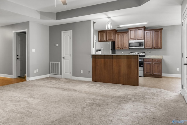 29929 Park Hill Dr, Madison, AL 35757 - kitchen featuring stainless steel appliances, light colored carpet, and baseboards