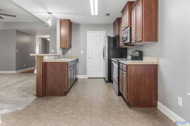 29929 Park Hill Dr, Madison, AL 35757 - kitchen featuring appliances with stainless steel finishes, a sink, baseboards, and light countertops
