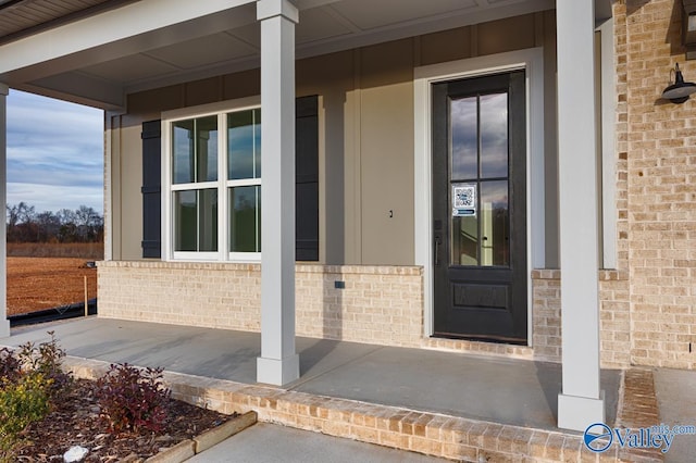 view of exterior entry with a porch