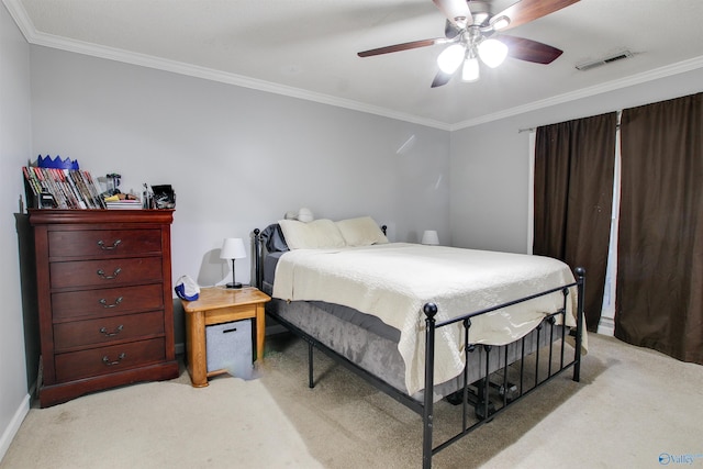 bedroom with ornamental molding, a ceiling fan, visible vents, and light carpet