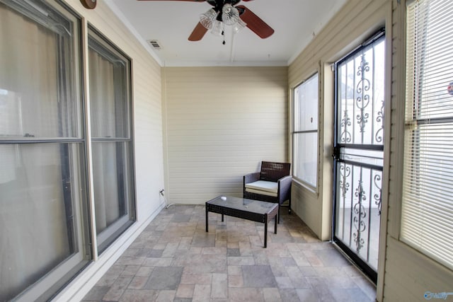 sunroom / solarium featuring visible vents and a ceiling fan