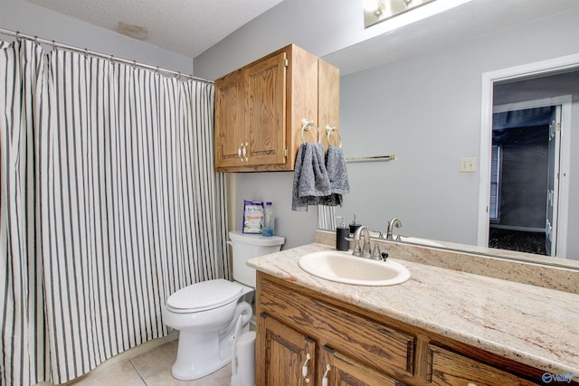 bathroom featuring tile patterned floors, a shower with curtain, toilet, a textured ceiling, and vanity