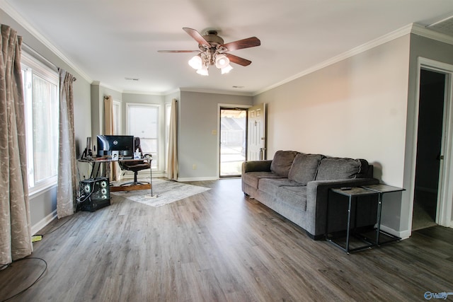 living room with ceiling fan, a wealth of natural light, and wood finished floors