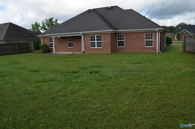 back of house featuring brick siding, a patio, and a shingled roof