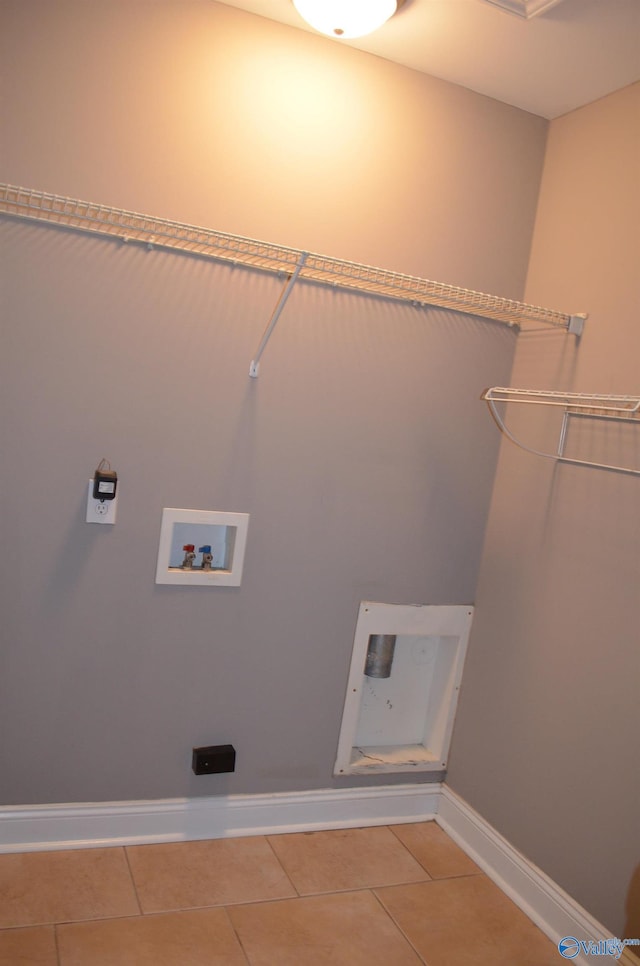 laundry area with light tile patterned floors, baseboards, and hookup for a washing machine