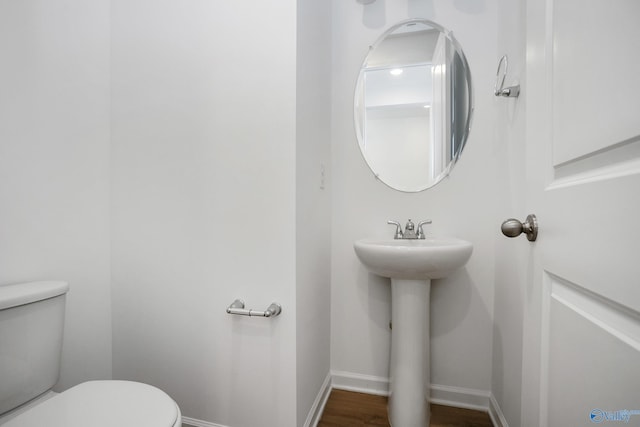 bathroom featuring toilet and hardwood / wood-style floors