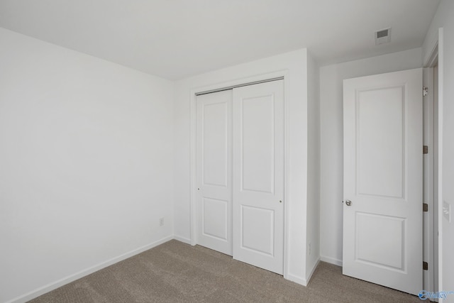 unfurnished bedroom featuring a closet and carpet