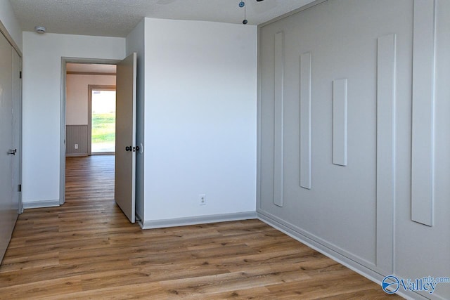 unfurnished bedroom with light wood-type flooring and baseboards