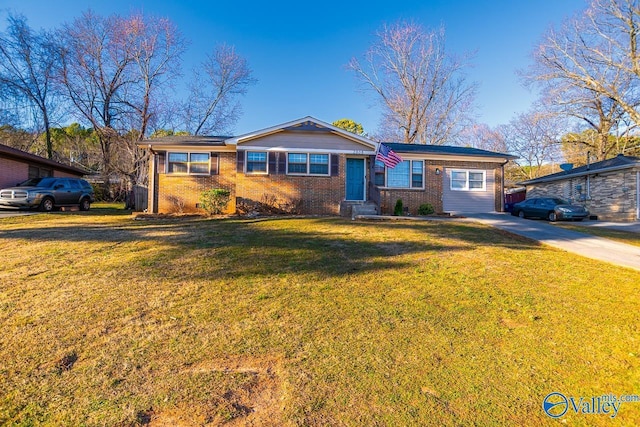 ranch-style home with driveway, brick siding, and a front yard