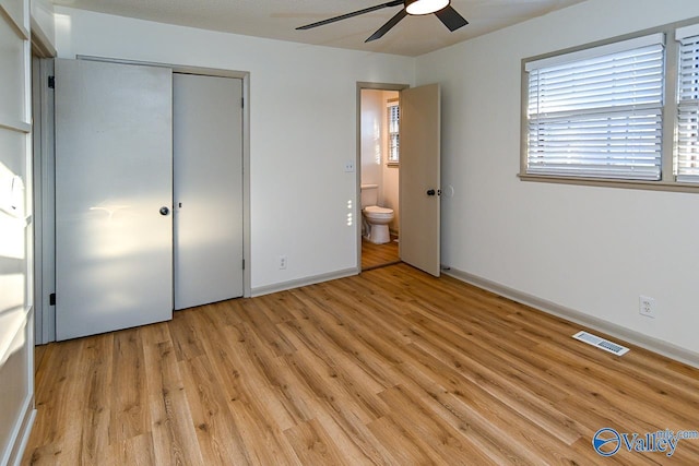 unfurnished bedroom with light wood-style flooring, a closet, visible vents, and baseboards