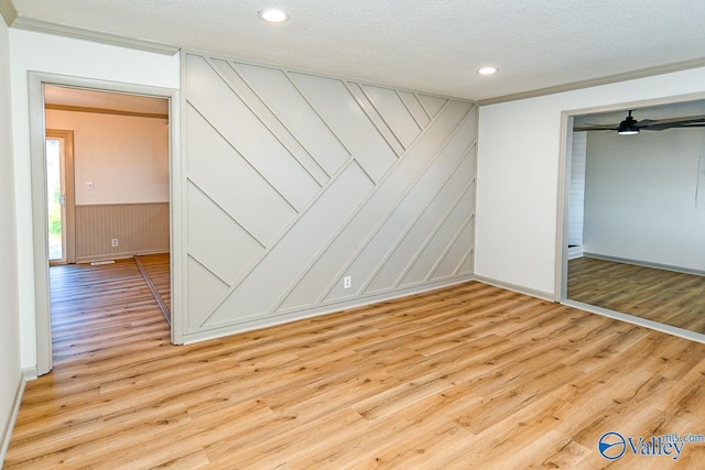 unfurnished bedroom with light wood-style flooring, a textured ceiling, and recessed lighting