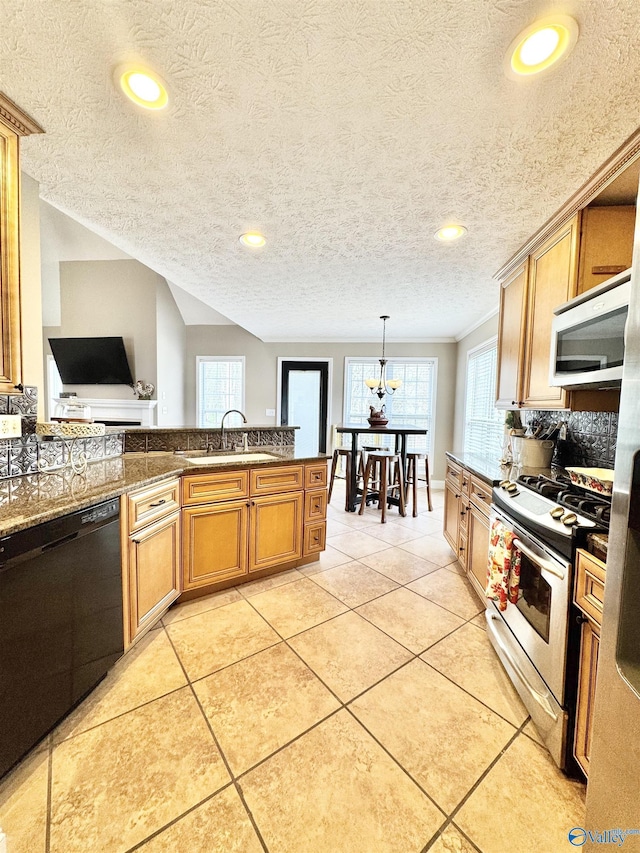 kitchen with light tile patterned floors, stainless steel appliances, backsplash, a sink, and brown cabinetry