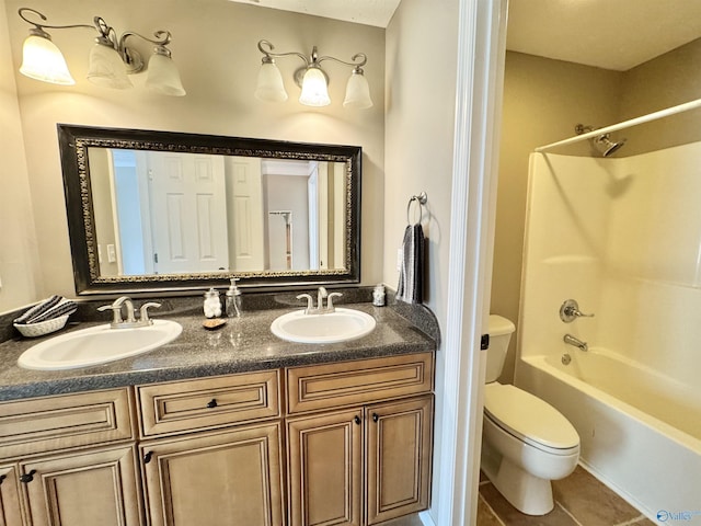 full bathroom featuring double vanity, a sink, toilet, and tile patterned flooring