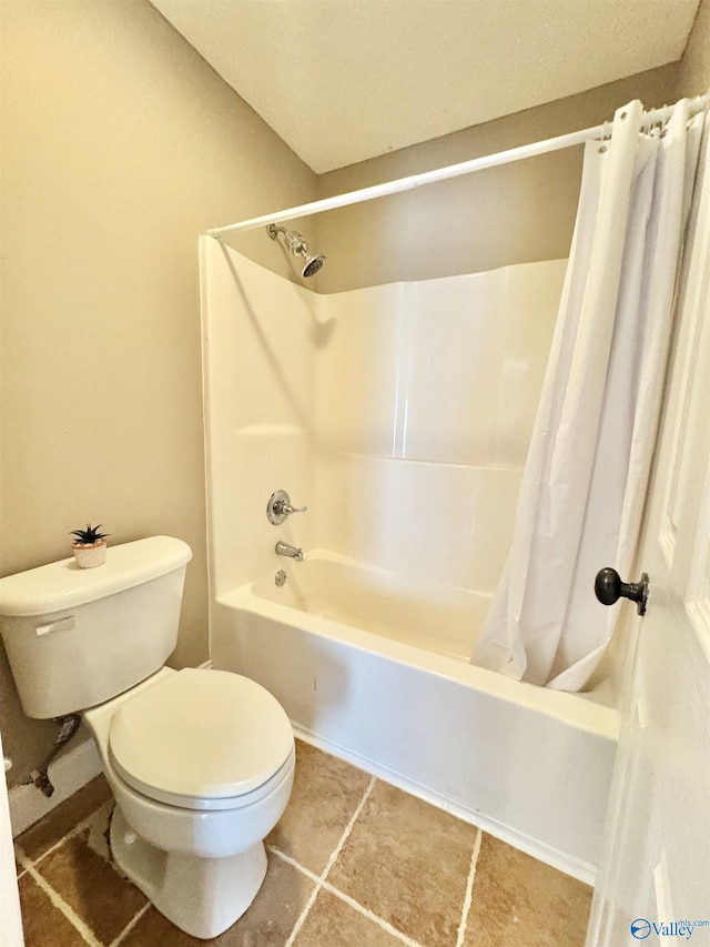 full bath with toilet, tile patterned floors, and shower / tub combo with curtain