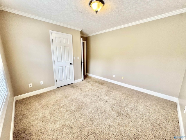 unfurnished bedroom with baseboards, carpet flooring, a textured ceiling, and crown molding